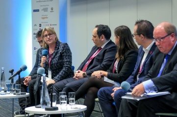 Dr. Bridget McConnell CBE (speaking) and Paul Bush OBE (far right) at a previous Host City, alongside (L-R) Alban Dechelotte, Riot Games; Dimitri Kerkentzes, BIE; Ansley O’Neal, IOC; and Jon Dutton, Rugby League World Cup 2021 (Photo Credit: Host City)